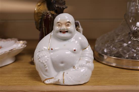 A Shiwan sang-de-boeuf glazed figure of a luohan and an enamelled porcelain figure of a Budai tallest 16cm